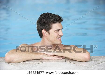 Young Man Resting On Edge Of Swimming Pool View Large Photo Image Stock Photo - Young Man Resting On Edge Of Swimming Pool. Fotosearch