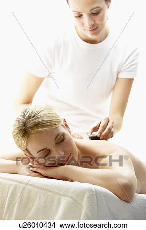 Young Woman Enjoying Hot Stone Treatment View Large Photo Image Picture - Young Woman Enjoying Hot Stone Treatment. Fotosearch