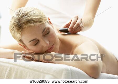 Young Woman Enjoying Hot Stone Treatment View Large Photo Image Stock Image - Young Woman Enjoying Hot Stone Treatment. Fotosearch