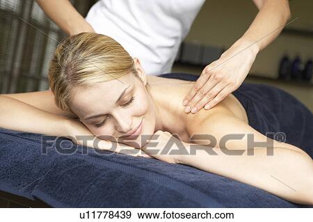 Stock Photo - Young Woman Enjoying Hot Stone Treatment. Fotosearch