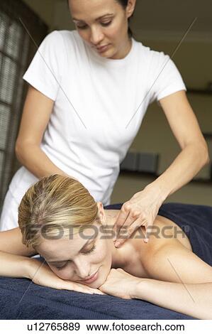 Young Woman Enjoying Hot Stone Treatment View Large Photo Image Stock Photo - Young Woman Enjoying Hot Stone Treatment. Fotosearch