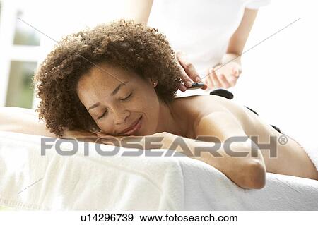 Young Woman Enjoying Hot Stone Treatment View Large Photo Image Stock Photo - Young Woman Enjoying Hot Stone Treatment. Fotosearch