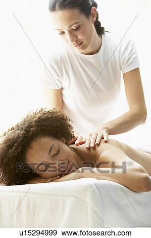 Stock Photo - Young Woman Enjoying Hot Stone Treatment. Fotosearch