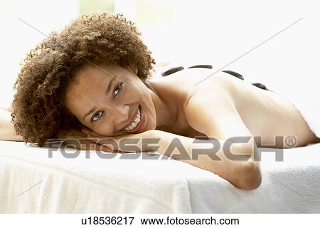 Young Woman Enjoying Hot Stone Treatment View Large Photo Image Stock Photo - Young Woman Enjoying Hot Stone Treatment. Fotosearch