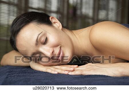 Stock Image - Young Woman Relaxing On Massage Table. Fotosearch