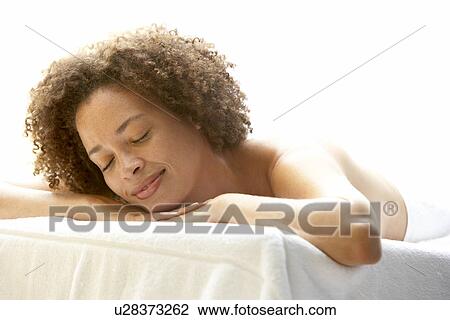 Stock Image - Young Woman Relaxing On Massage Table. Fotosearch