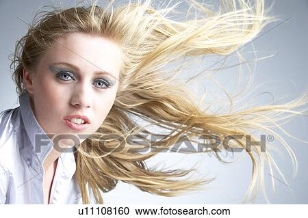 Young Woman With Hair Blowing Behind View Large Photo Image Stock Image - Young Woman With Hair Blowing Behind. Fotosearch