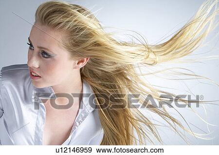 Young Woman With Hair Blowing Behind View Large Photo Image Stock Photo - Young Woman With Hair Blowing Behind. Fotosearch