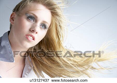 Young Woman With Hair Blowing Behind View Large Photo Image Stock Photo - Young Woman With Hair Blowing Behind. Fotosearch