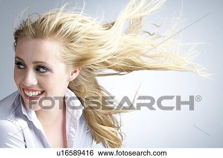 Young Woman With Hair Blowing Behind View Large Photo Image Stock Photograph - Young Woman With Hair Blowing Behind. Fotosearch