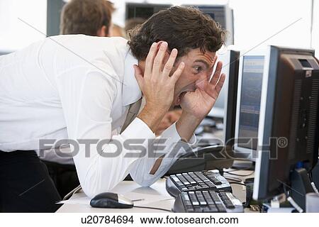 Picture - Businessman Looking Shocked At Monitor. Fotosearch