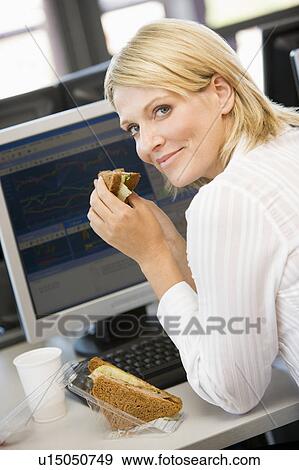 Businesswoman Enjoying Sandwich During Lunchbreak View Large Photo Image Stock Photo - Businesswoman Enjoying Sandwich During Lunchbreak. Fotosearch