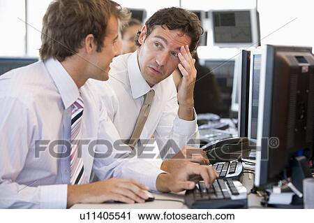 Stock Image - Colleagues Working Together At Computer. Fotosearch