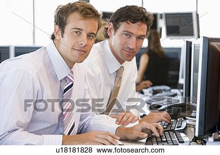 Stock Photo - Colleagues Working Together At Computer. Fotosearch