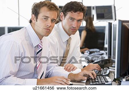 Stock Photograph - Colleagues Working Together At Computer. Fotosearch