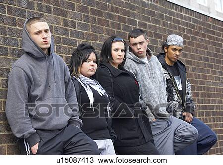Stock Image - Gang Of Youths Leaning On Wall. Fotosearch