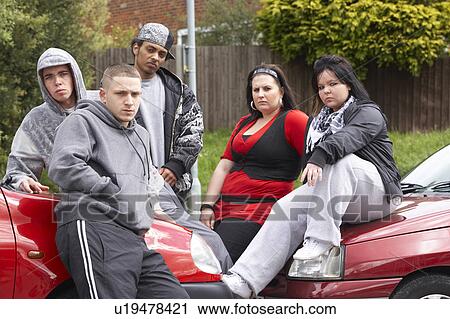 Stock Image - Gang Of Youths Sitting On Cars. Fotosearch