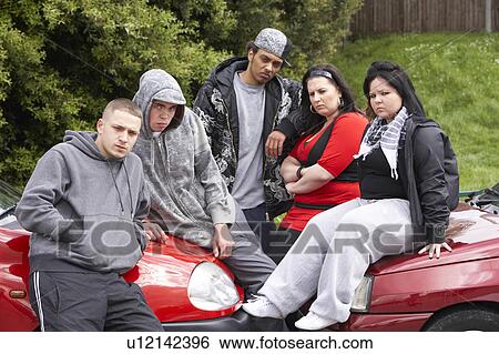 Gang Of Youths Sitting On Cars View Large Photo Image Stock Photograph - Gang Of Youths Sitting On Cars. Fotosearch