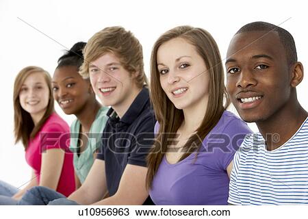 Stock Image - Group Of Teenage Friends In Studio. Fotosearch