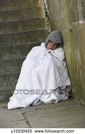 Stock Photography - Homeless Boy Sleeping Rough. Fotosearch