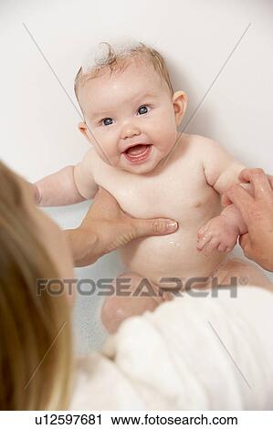 Mother Bathing Baby At Home View Large Photo Image Stock Image - Mother Bathing Baby At Home. Fotosearch