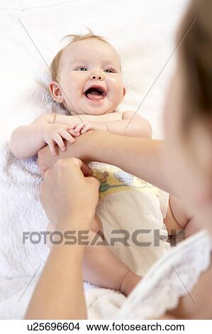 Picture - Mother Changing Baby Nappy. Fotosearch