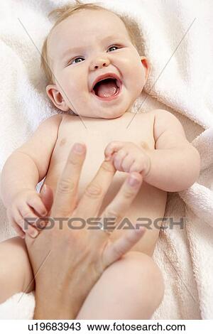 Stock Image - Mother Drying Baby After Bath. Fotosearch