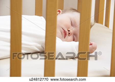 Stock Image - Newborn Baby In Cot. Fotosearch
