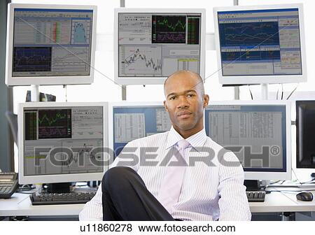 Portrait Of Stock Trader In Front Of Computer Monitors View Large Photo Image Stock Photo - Portrait Of Stock Trader In Front Of Computer Monitors. Fotosearch