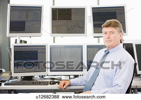 Stock Photo - Portrait Of Stock Trader In Front Of Computer Monitors. Fotosearch