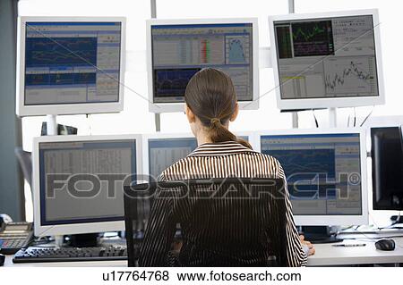 Stock Trader Looking At Multiple Monitors View Large Photo Image Stock Photo - Stock Trader Looking At Multiple Monitors. Fotosearch