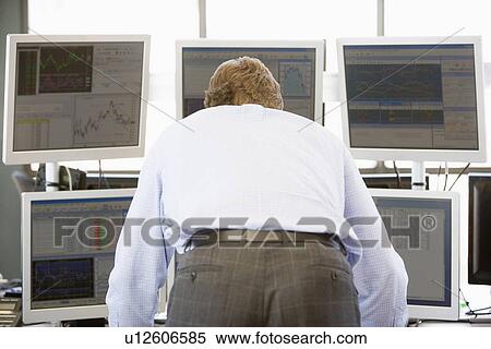 Stock Trader Looking At Multiple Monitors View Large Photo Image Stock Photography - Stock Trader Looking At Multiple Monitors. Fotosearch