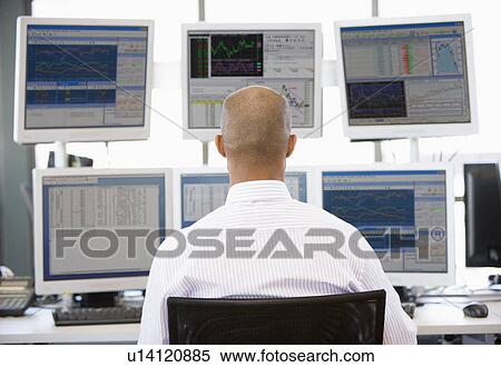 Stock Trader Looking At Multiple Monitors View Large Photo Image Stock Photography - Stock Trader Looking At Multiple Monitors. Fotosearch