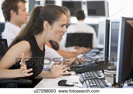 Stock Image - Stock Trader Looking Exasperatedly At Monitor. Fotosearch