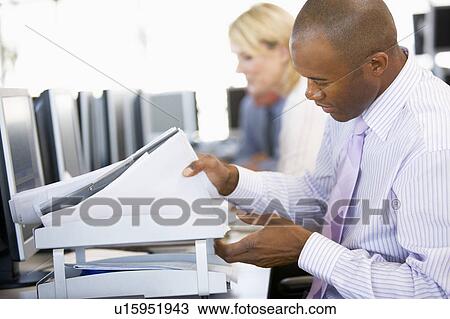 Stock Image - Stock Trader Looking Though Paperwork. Fotosearch