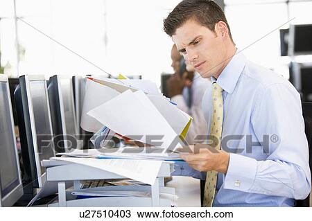 Stock Trader Looking Though Paperwork View Large Photo Image Stock Image - Stock Trader Looking Though Paperwork. Fotosearch