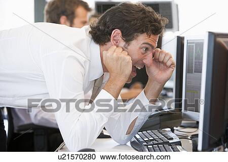 Stock Image - Stock Trader Overjoyed Looking At Monitor. Fotosearch