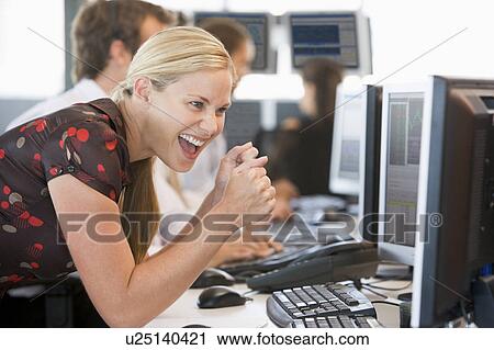 Stock Image - Stock Trader Overjoyed Looking At Monitor. Fotosearch