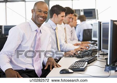 Stock Image - Stock Traders At Work. Fotosearch