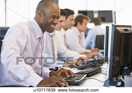 Stock Photo - Stock Traders At Work. Fotosearch