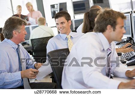 Stock Photo - Stock Traders At Work. Fotosearch