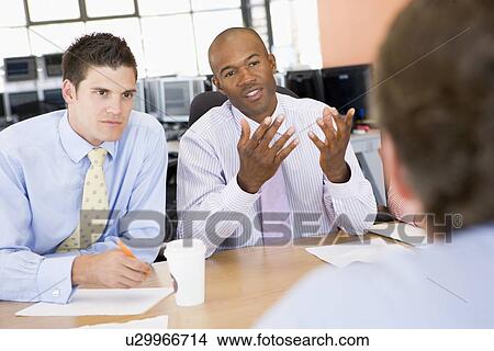 Picture - Stock Traders Conducting Interview. Fotosearch