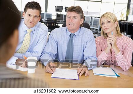 Stock Image - Stock Traders Conducting Interview. Fotosearch