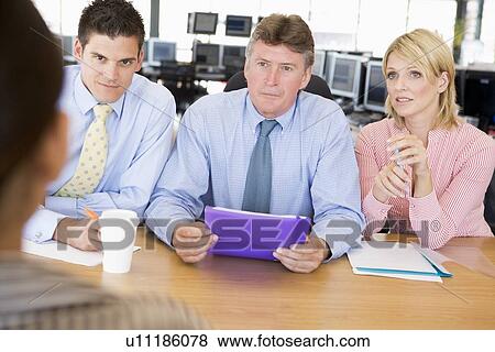 Stock Photo - Stock Traders Conducting Interview. Fotosearch
