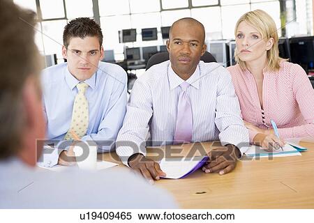 Stock Photography - Stock Traders Conducting Interview. Fotosearch