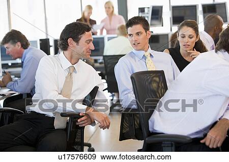 Stock Photo - Stock Traders In Conversation. Fotosearch