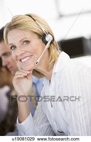Stock Photo - Stock Traders With Headsets At Work. Fotosearch