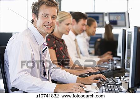 Stock Image - Stock Traders Working At Computers. Fotosearch