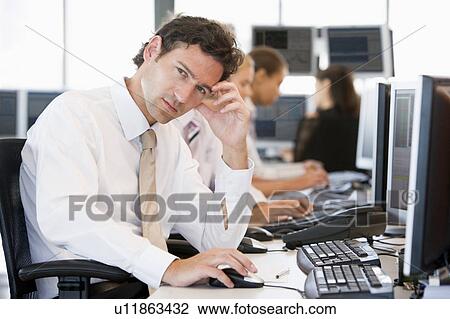 Stock Image - Stock Traders Working At Computers. Fotosearch