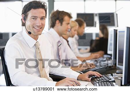 Stock Image - Stock Traders Working At Computers. Fotosearch